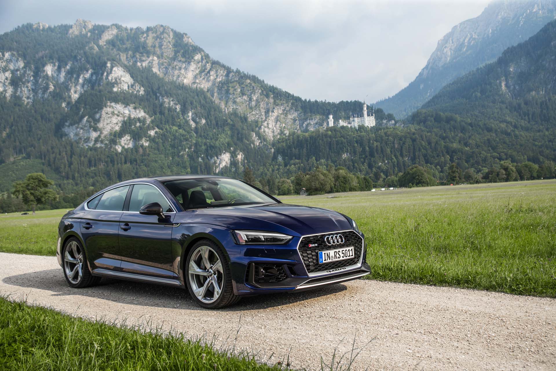 AUDI RS 5 SPORTBACK front angular view mountains on the background