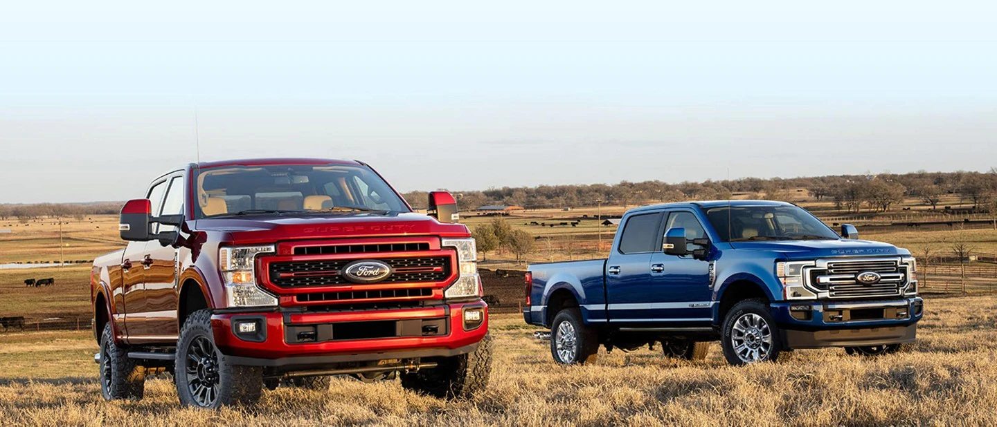 two cars of red and blue Ford F-250 Super Duty 