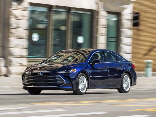 blue toyota avalon driving in the city
