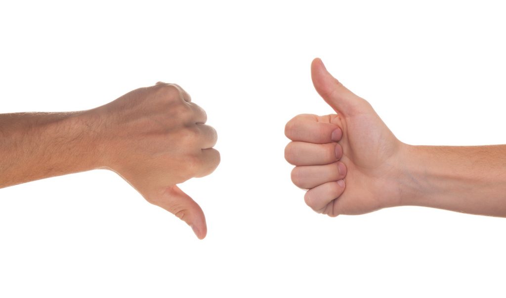 two hands showing thumbs up and down