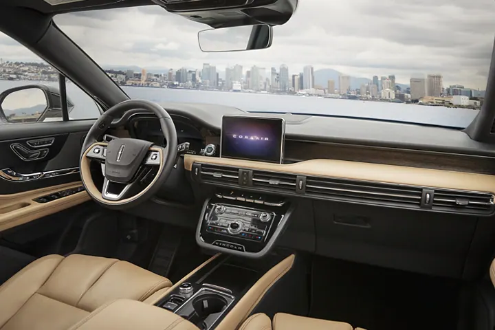 The sand-coloured interior of 2021 Lincoln Corsair with black details and the city view