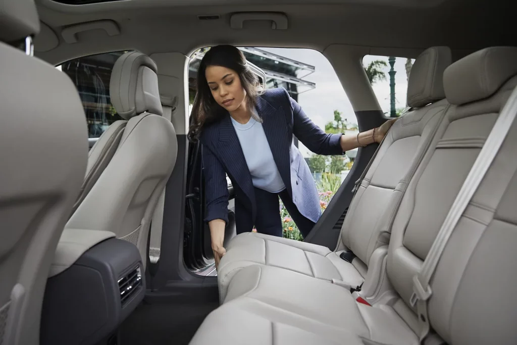 The woman tries to set the rear seats in the 2021 Lincoln MKC