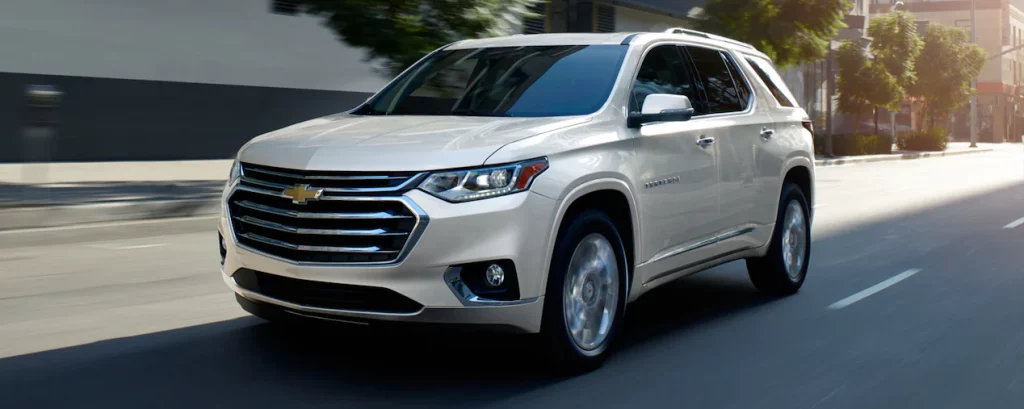 pearl white 2021 chevrolet traverse in the motion