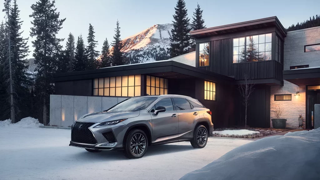 front angular view of 2021 Lexus RX 350 near the mansion on the snowy mountains background