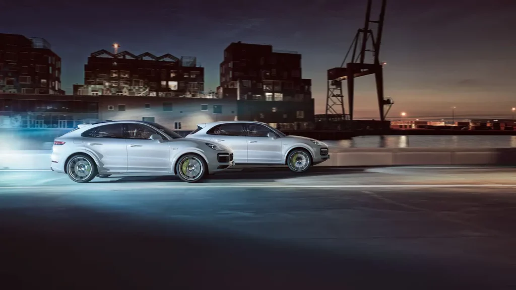 side view of two cars of 2021 porsche cayenne in the motion near the port 