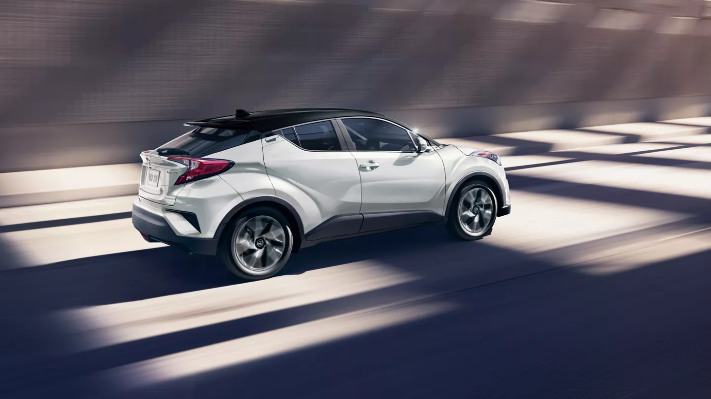 side view of white toyota chr in a motion