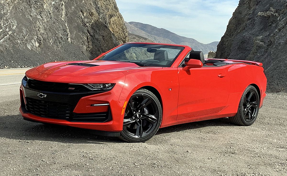 red chevrolet camaro convertible in the mountains front angular view