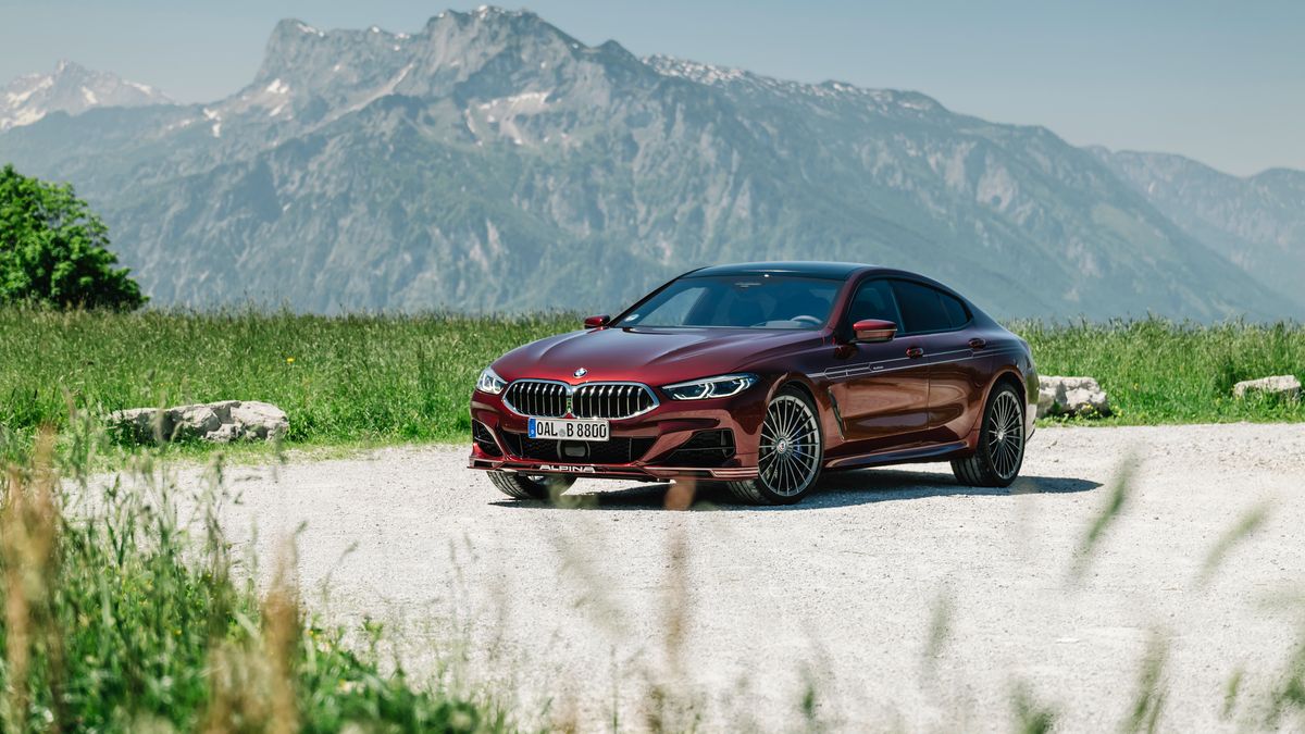 BMW ALPINA B8 Gran Coupe lease on the highway mountain background red auto