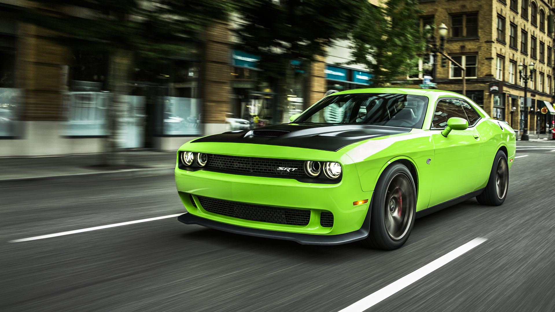 neon yellow Dodge Challenger SRT Hellcat front angular view in the motion