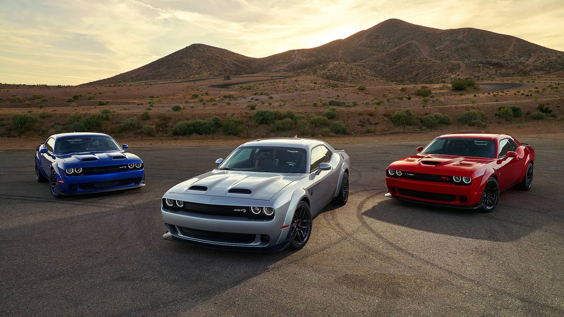 three Dodge cars in the desert