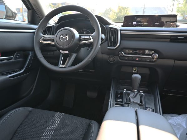 Images of 2025 Mazda CX-50 exterior, interior, tech dashboard, and side view